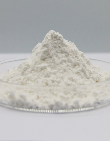 White magnesium powder piled on a clear glass dish against a gray background.