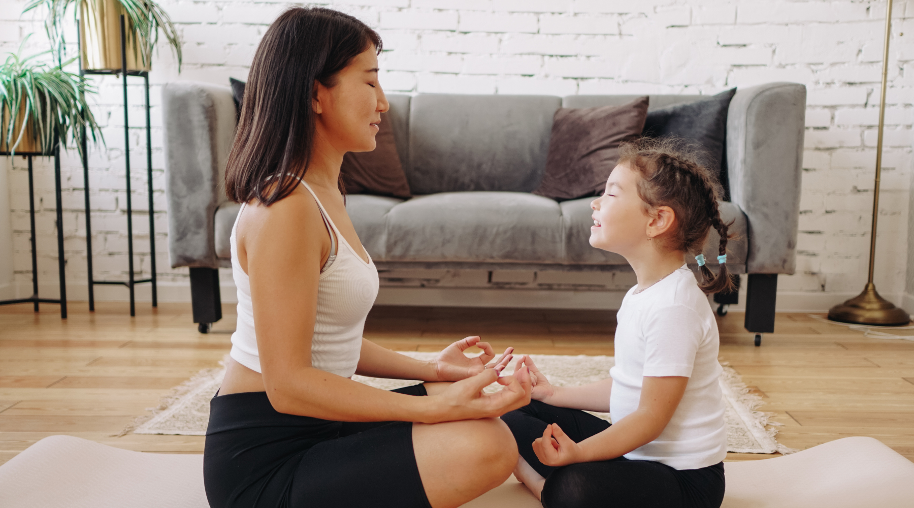 Mother and daughter meditating together