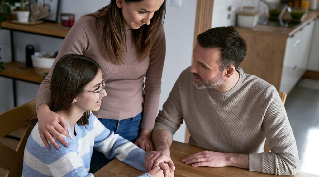 Mother and father talk to teen daughter about mental health